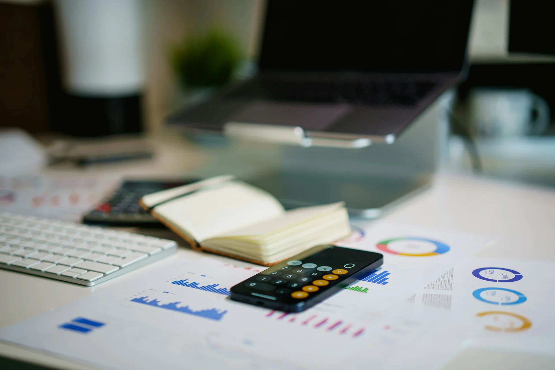 Accountant's desk with calculator, notebook and financial reports