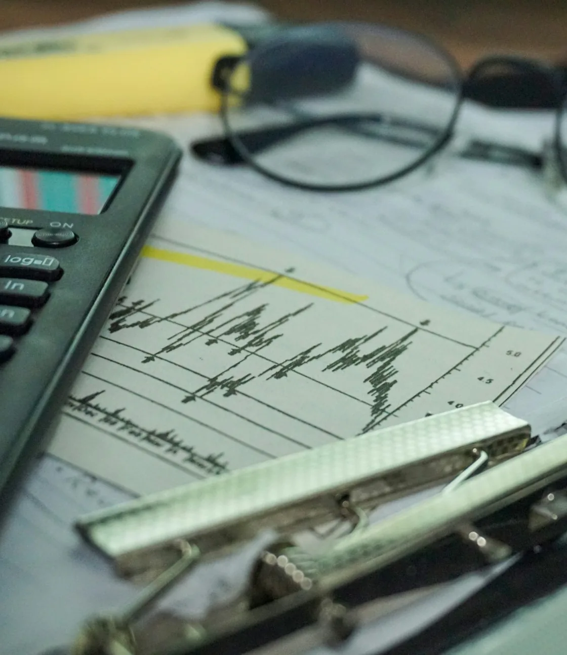 Calculator and financial chart on an adviser's desk