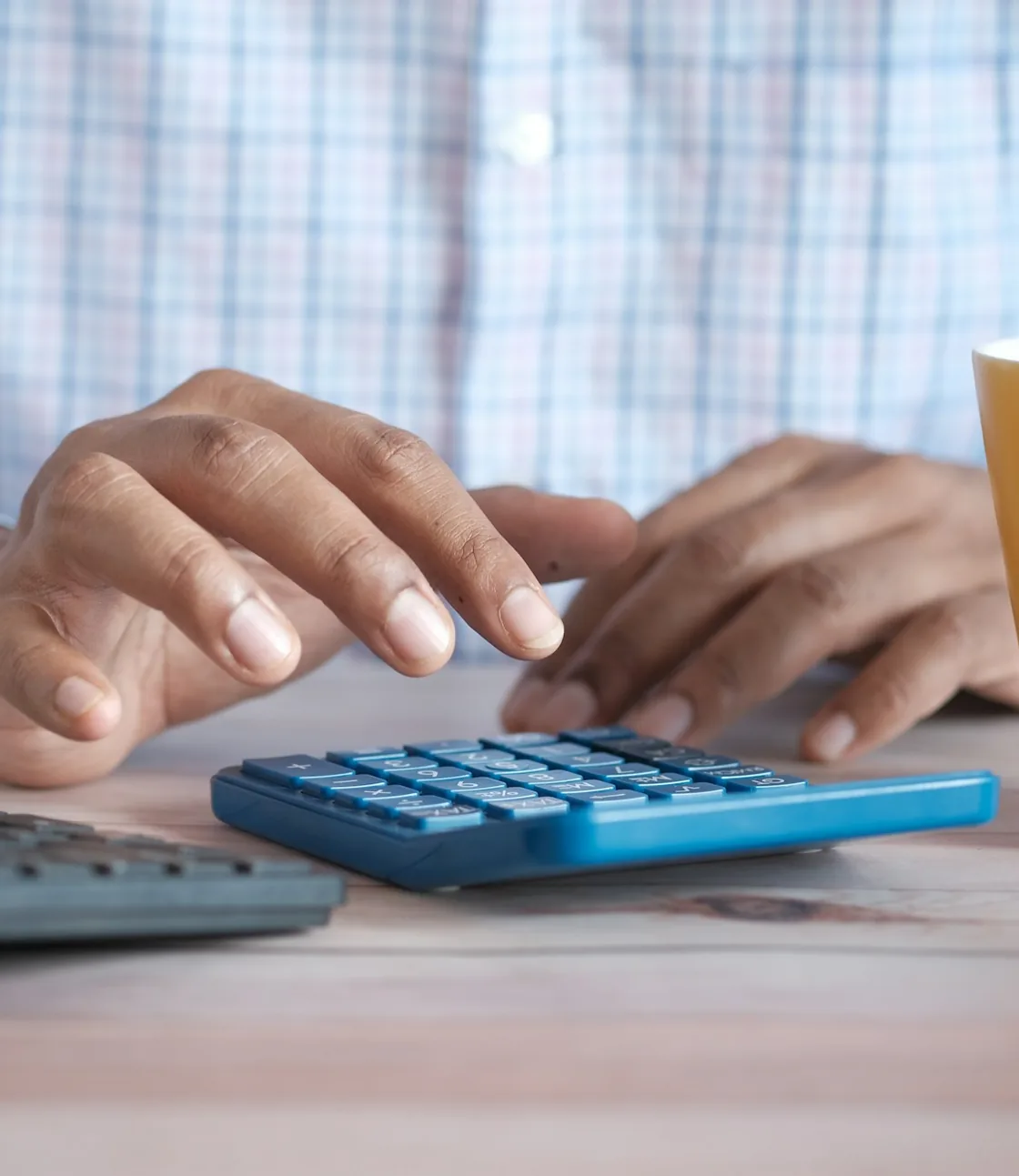 Payroll figures being entered on a calculator